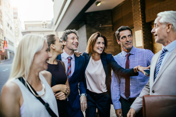 Diverse group of business people and coworkers commuting to work together in the city