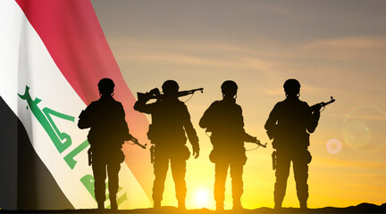 Fototapeta na wymiar Silhouettes of a soldiers with Iraq flag against the sunset. EPS10 vector