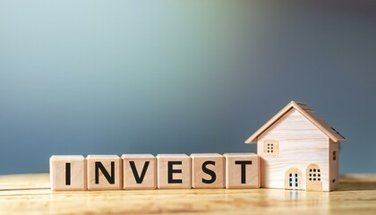 New Writing world "INVEST" text on a wooden cube block and house model