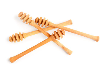 Wooden honey dippers isolated on white background