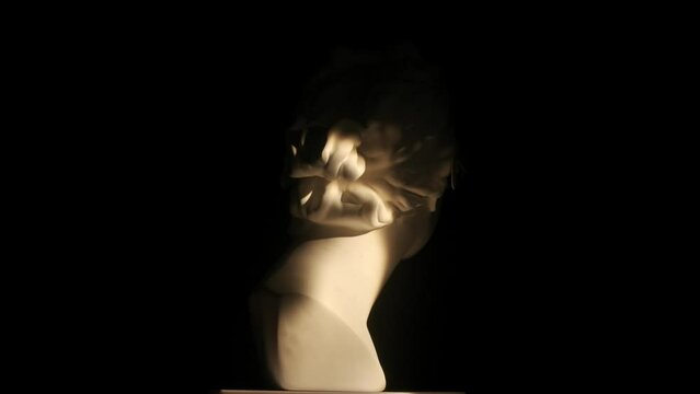 Closeup shot. Ancient marble bust statue of roman era woman in 3d glasses spinning round on a platform with selective lights set. Isolated on black background. HDR BT2020 HLG Material.