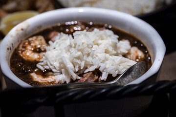 Seafood gumbo with rice and crab fingers.