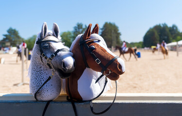 Hobby horses are waiting for the riders. Equestrian sports. Equestrian equipment. Sports. Summer....