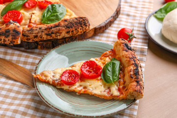 Plate with slice of tasty pizza Margarita on table