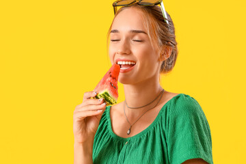 Young woman eating fresh watermelon on yellow background, closeup