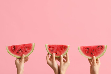 Female hands with slices of ripe watermelon on pink background