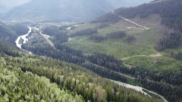 Drone Aerial Tilt-Up Nature Shot of Valley in British Columbia Beaver Canada
View of Mountains, Trees, Kinbasket Lake, Mountains, Forest, Sky, Clouds | Tilt Up Showing Aerial Natural Valley Landscape