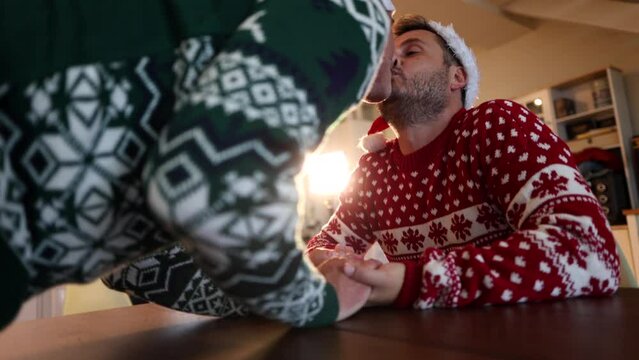 Proyecto sin título 8beautiful Christmas kiss with a light against an adult couple of gay men in the living room of their house