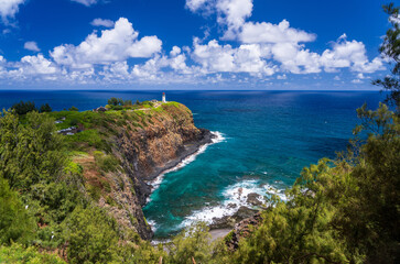 Fototapeta premium Kilauae Lighthouse on headland above turquoise bay on north coast of Kauai in Hawaii