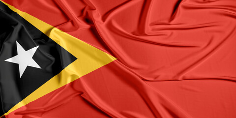 East Timor official national flag of silk fabric texture. Waving Fabric Flag of East Timor