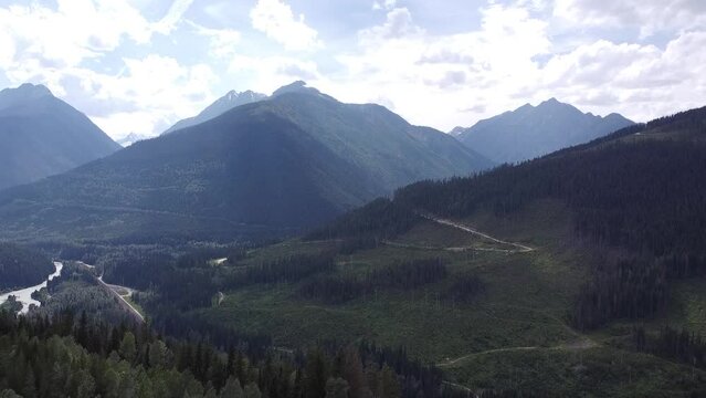 As the drone soars outwards from the valley, it offers a unique perspective on the natural beauty of the region.

Nature Shot of Forest, Trees, Lake, Mountains, Sky, Clouds