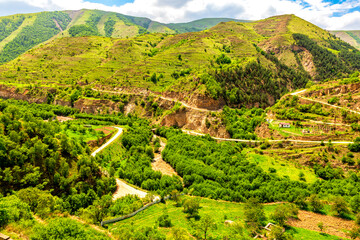 Top view of a wide gorge in the mountains of Dagestan with a network of dirt roads and an...