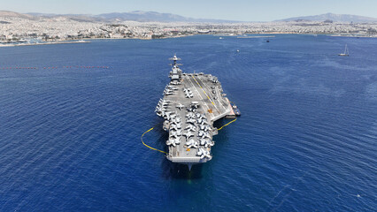 Aerial drone photo of latest technology American flag nuclear aircraft carrier anchored in deep...