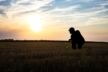 Silhouette Real Farmer Inspects Double Crop Beans at Sunset