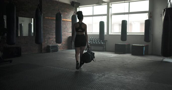 Gym, walking and woman with a bag for exercise, sports training or workout for wellness. Back of an athlete person morning arrival at health club to start fitness, strong body and commitment