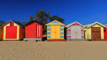 Fototapeta na wymiar Partial run of the 82 brightly painted Victorian bathing boxes on Dendy Street Beach, Brighton suburb. Melbourne-Australia-898