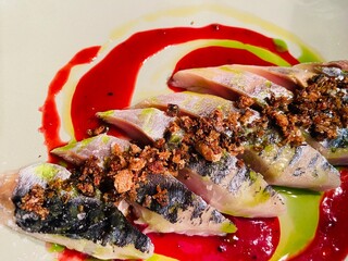 Mackerel boquerones with raspberry jus and olive oil and pangratatta 
