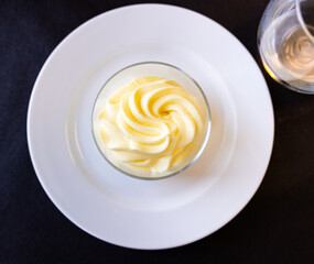 Service dish containing sweet lemon sorbet on the laid table in restaurant