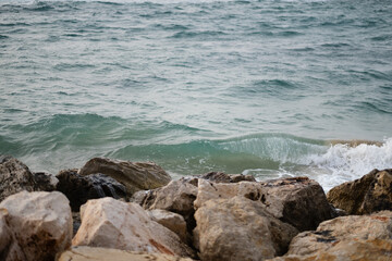 The waves of the Mediterranean Sea crash against boulders along the shoreline of Tel Aviv, near Jaffa.