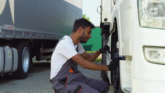 Indian mechanic changes the truck tire