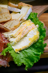 Fresh cuts of French cured sausages, ham, cheeses for party close up