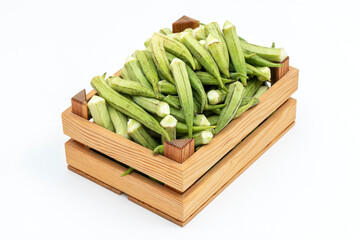 Fresh okra on the wooden container.
