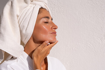 with the procedure of applying a moisturizing cream on a woman's face