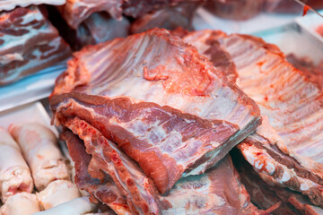 Raw pork ribs laid out on counter in butcher shop