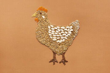 Creative composition of hen made up of beans and cereal grains against orange background 