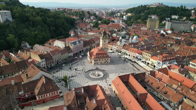 Drone footage over the old city center of Brasov, capturing buildings and people.Brasov, Romania
