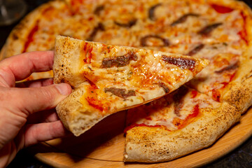 Traditional anchovy pizza (alicci) with artisan long-matured dough. 