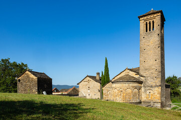 Well-preserved Romanesque stone Church of San Pedro with robust bell tower in Larrede, part of...