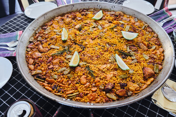 Authentic Valencia Spanish Paella. Grains of rice, with lemon, beans, spices and rabbit meat.