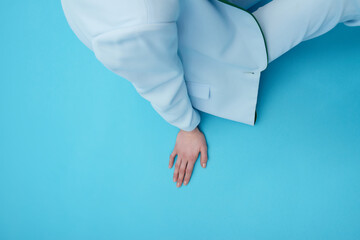 Conceptual photo of unrecognizable woman in elegant suit against vivid blue background 