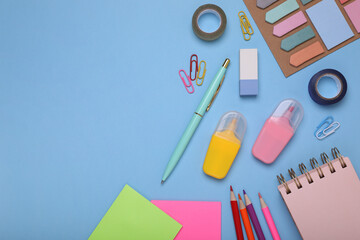 Flat lay composition with different school stationery on light blue background, space for text. Back to school