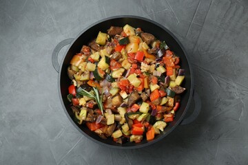 Delicious ratatouille in baking dish on grey table, top view