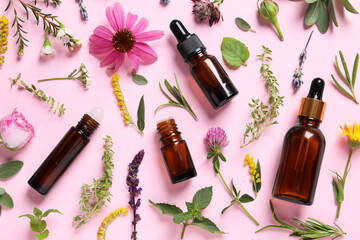 Bottles of essential oils, different herbs and flowers on pink background, flat lay