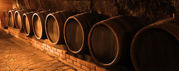 Many wooden barrels in cellar, banner design