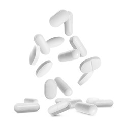 Many different pills falling on white background
