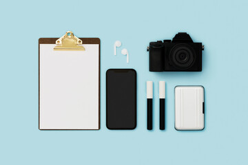 Stationary flat lay with camera and smartphone on blue background