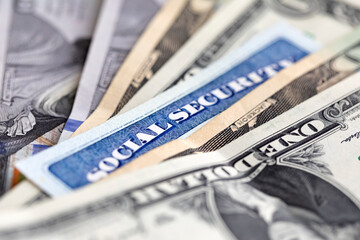 Social security card with US currency. Retirement benefit concept