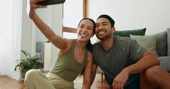 Couple, selfie and kiss with fitness, home living room and yoga mat for exercise, smile and post on web blog. Woman, man and photography for memory, profile picture and social media on floor in house