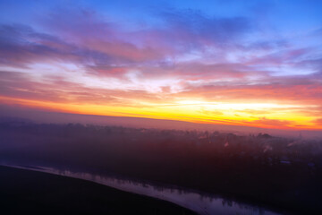 Aerial view of a foggy sunrise over the river