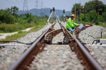 Engineer use theodolite equipment surveying construction worker on Railway site..