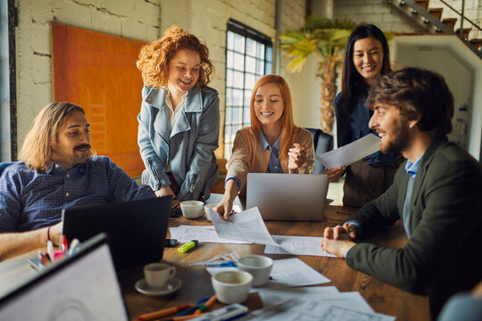 Young and diverse group of coworkers working on a project and having a meeting in a startup company office