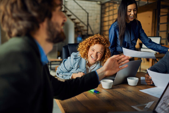 Young and diverse group of coworkers working on a project and having a meeting in a startup company office