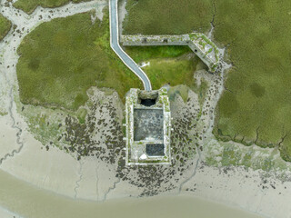 Aerial view of Carrigafoyle castle, ruined Irish tower house in Munster, off the Shannon estuary with defensive walls
