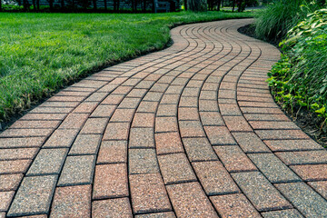 Brick pavers arranged in a curving pattern. - Powered by Adobe