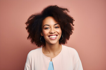 Obraz na płótnie Canvas portrait of black woman smiling in a studio, plain colour background