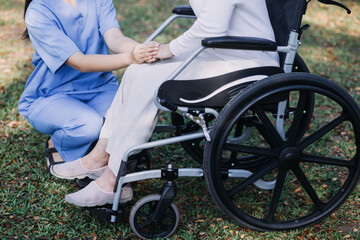 Obraz premium Asian young woman nurse at nursing home take care disabled senior man. Caregiver doctor serve physical therapy for older elderly patient to exercise and practice walking on walker or cane at backyard.